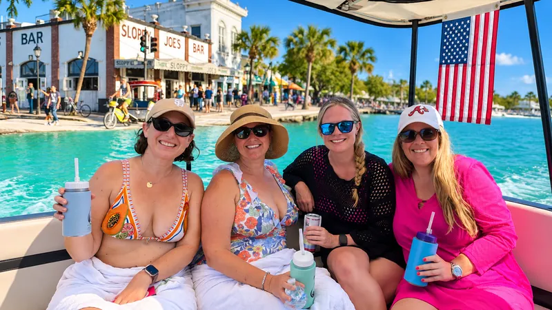 Four friends smiling aboard a Six Fins charter in Key West, beyond Duval Street