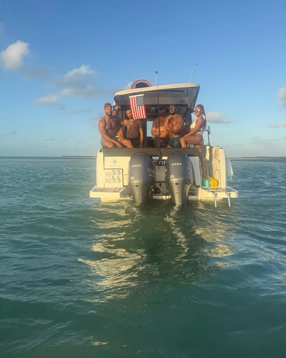 Friends gathered aboard a private Six Fins group charter boat on calm water off Key West