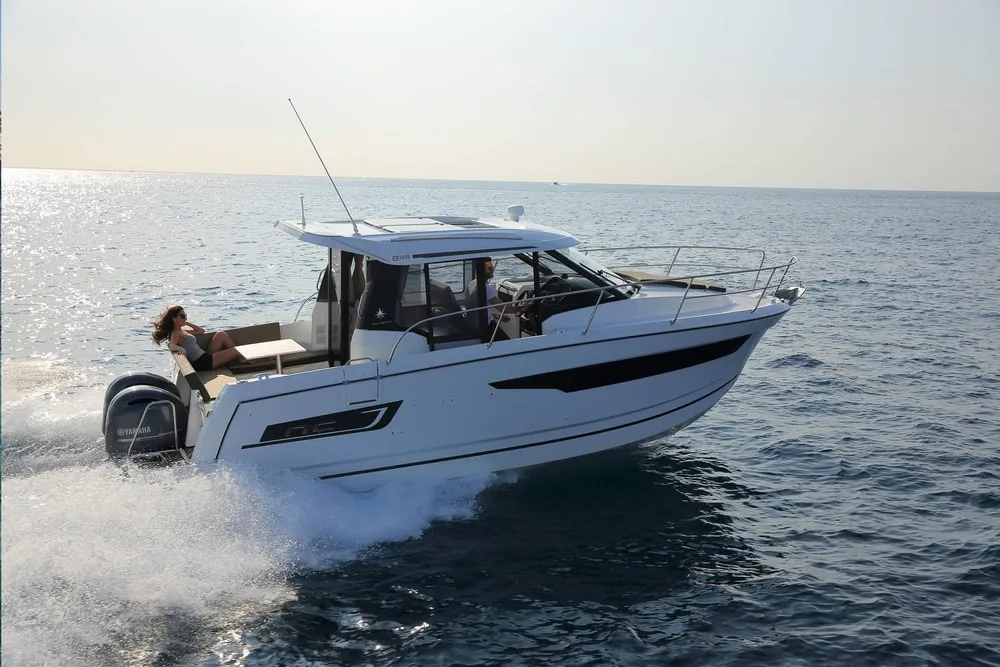 Six Fins Jeanneau powerboat cruising on calm water off Key West