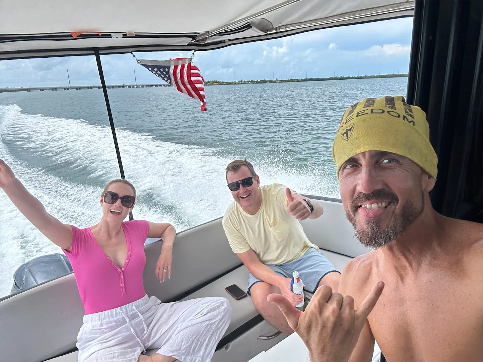 Guests taking a selfie aboard a Six Fins private boat charter on the water in Key West