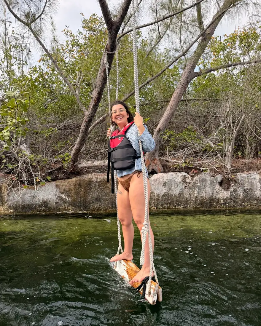 Six Fins jet ski tour guest on the rope swing at the Sub Pits near Key West