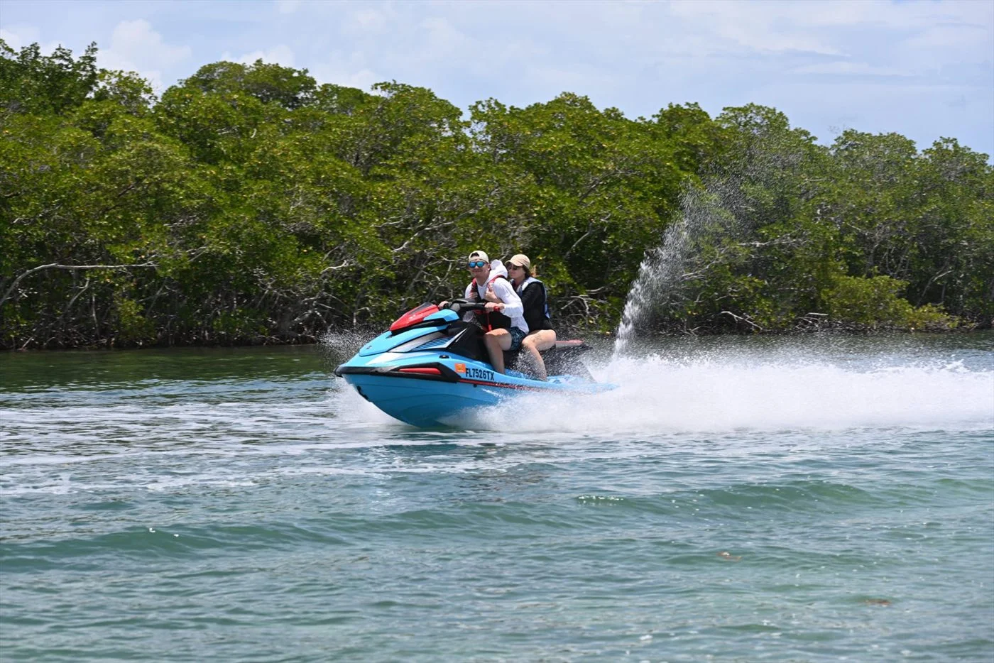 Jet ski cutting through clear blue water in Key West during spring break